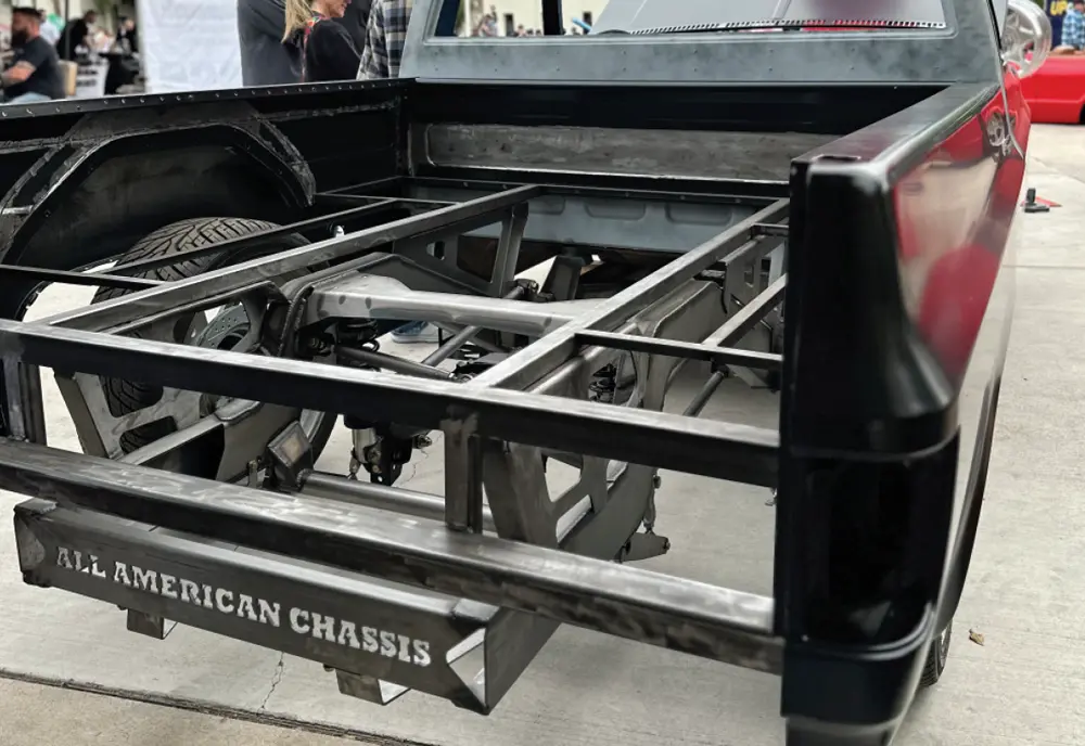 close cropped rear view of a black truck with its bed base removed to show the rear chassis