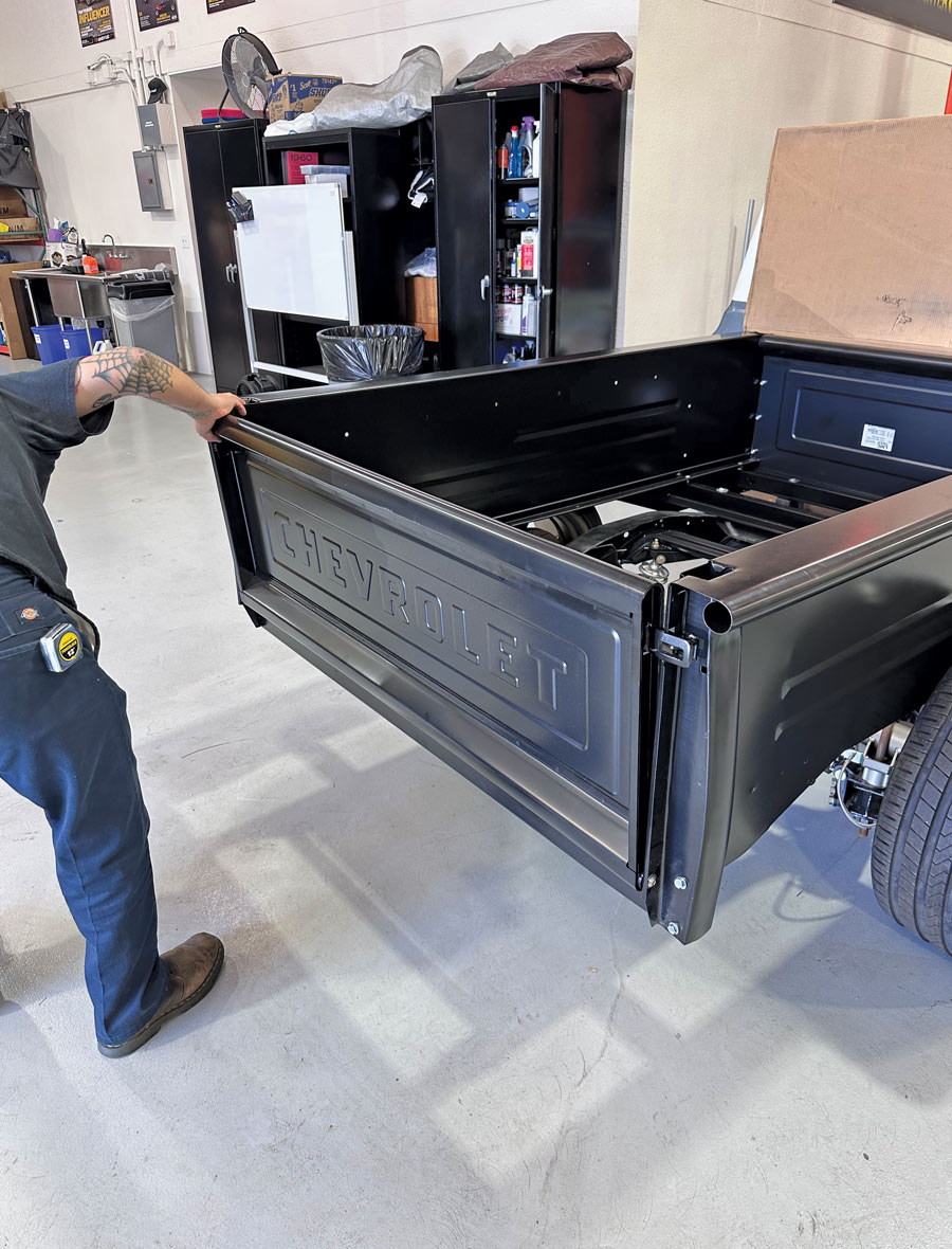 man checking tailgate and bed box alignment