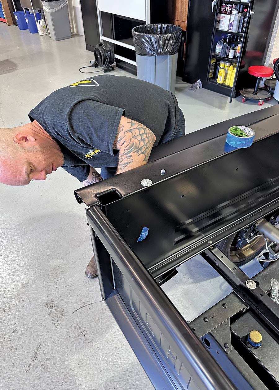 man adding painter's tape to bolts