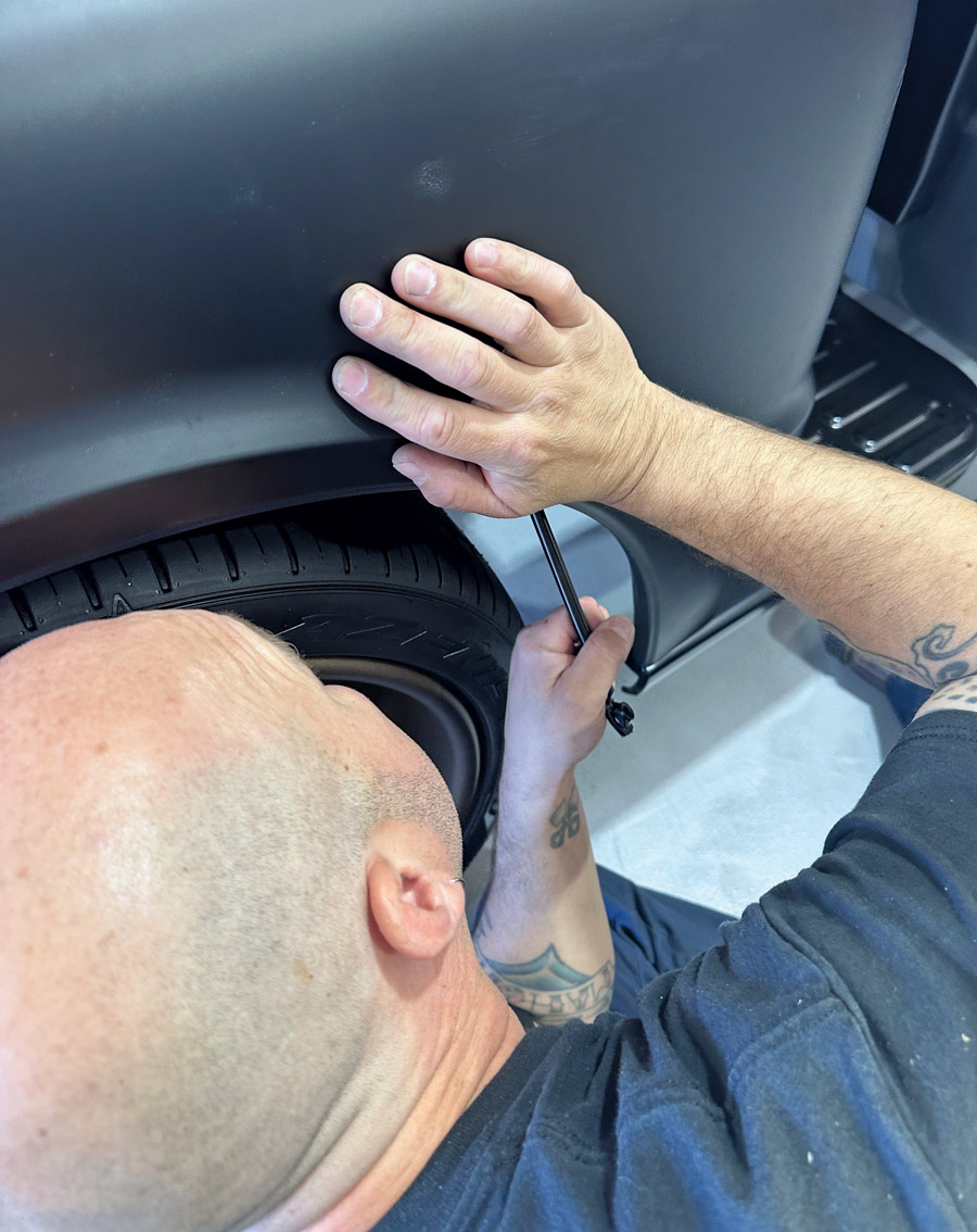 man using tool to install fender braces