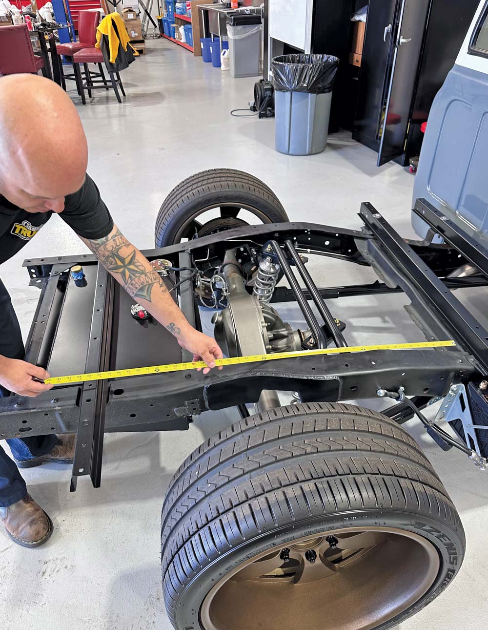 man measuring truck bed