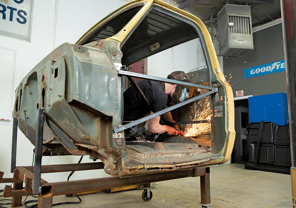 man removing flooring inside of the truck cab