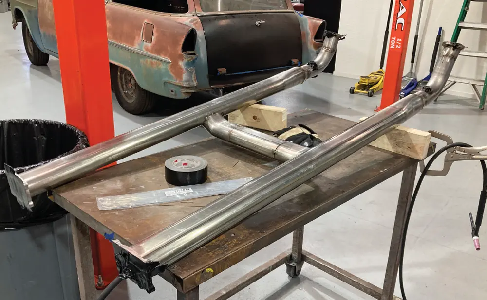 the front section of the C10’s exhaust tacked together and placed on a steel bench for final welding