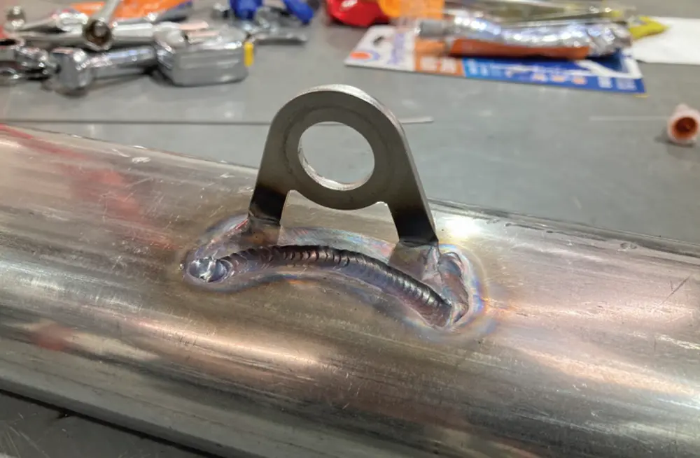 the Weld-On Exhaust Hanger on the bench after welding