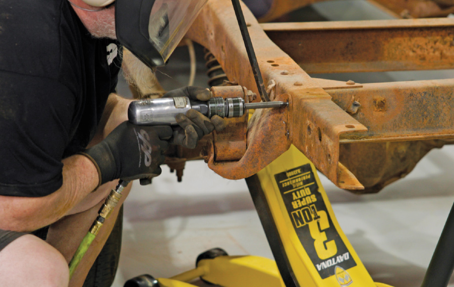 closeup of rear spring hangers being removed