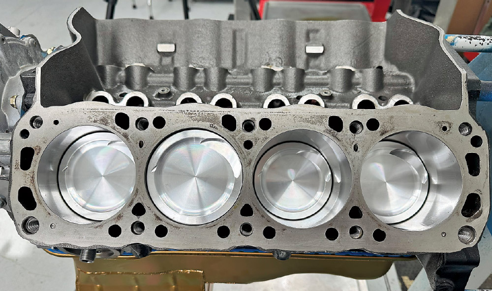 Fully assembled engine block with new pistons and cylinder walls visible