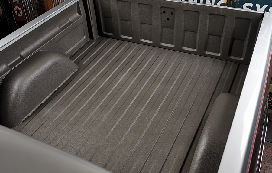 Bed of a 1994 Chevrolet C1500 with a sprayed-in bed liner, showing a clean, rugged finish