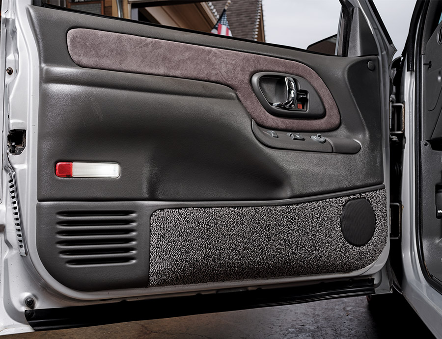 Interior door panel of a 1994 Chevrolet C1500 featuring a combination of black and gray materials