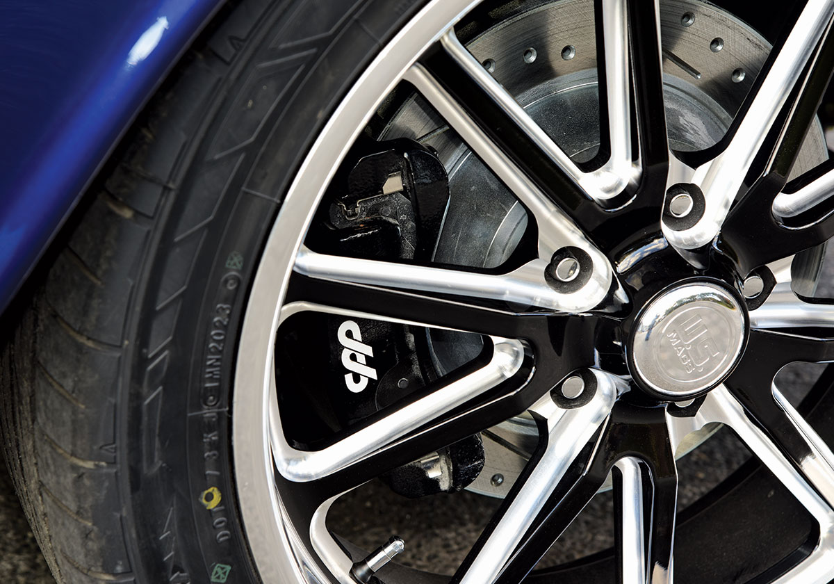 Close-up of a modern chrome and black wheel on a 1966 Chevrolet C10, showcasing CPP brakes behind the spokes