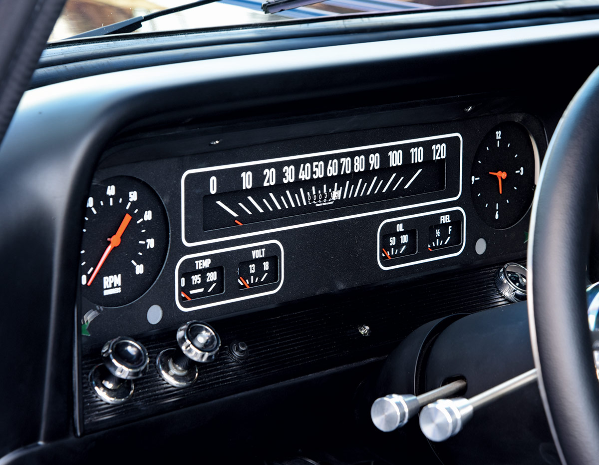 The driver's side of the 1966 Chevrolet C10's interior, displaying custom upholstery and a floor-mounted shifter