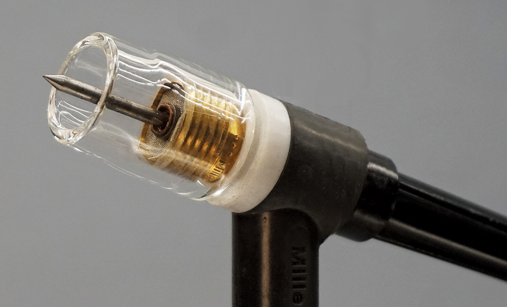 Close-up of clear TIG torch nozzle with tungsten electrode and gas lens setup