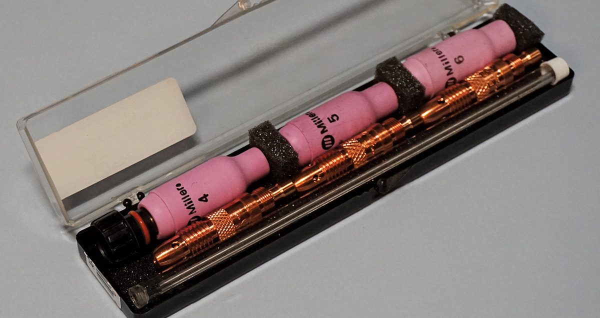 TIG torch parts kit, pink nozzles and copper collets, neatly organized in a plastic case