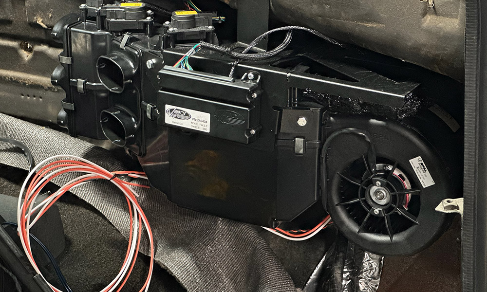 Newly installed air conditioning unit secured behind the dashboard of a 1990s Chevrolet CK 1500