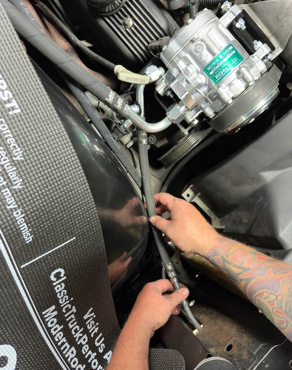 Routing and securing AC hoses in the engine bay of a 1990s Chevrolet CK 1500