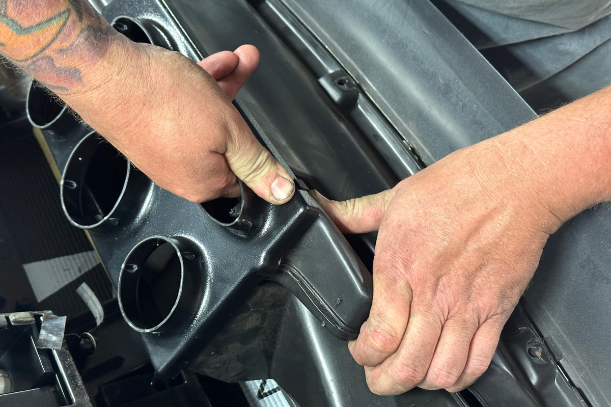 Positioning the dashboard vent assembly for installation in a 1990s Chevrolet CK 1500