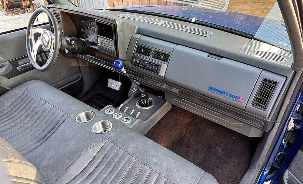 Interior view showcasing the dashboard and center console of a modified 1990s Chevrolet CK 1500