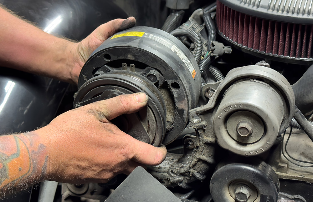 Securing a bracket for the air conditioning system in a 1990s Chevrolet CK 1500