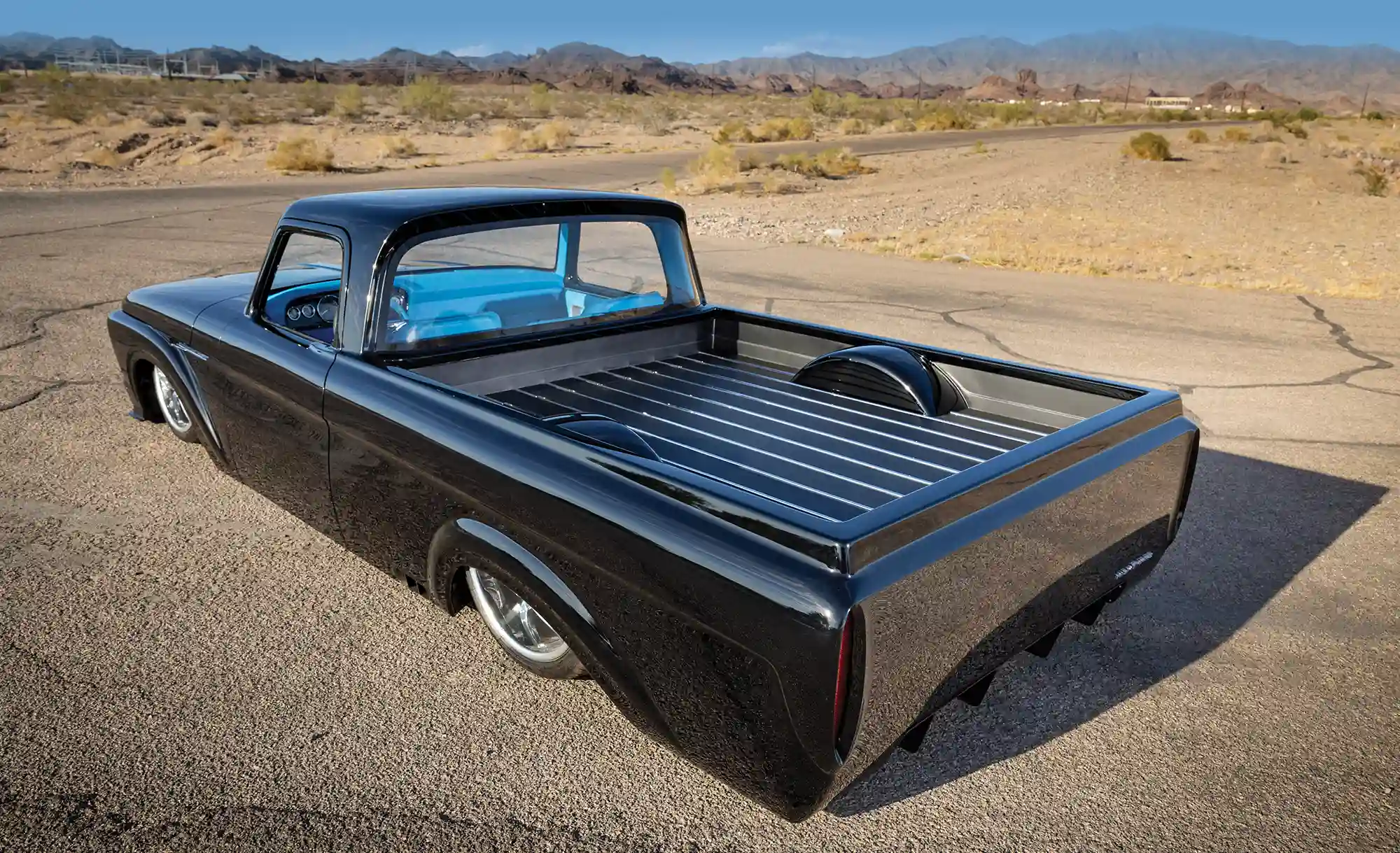 Head-on shot of the 1961 Ford F-100 with doors open, revealing its vibrant blue interior