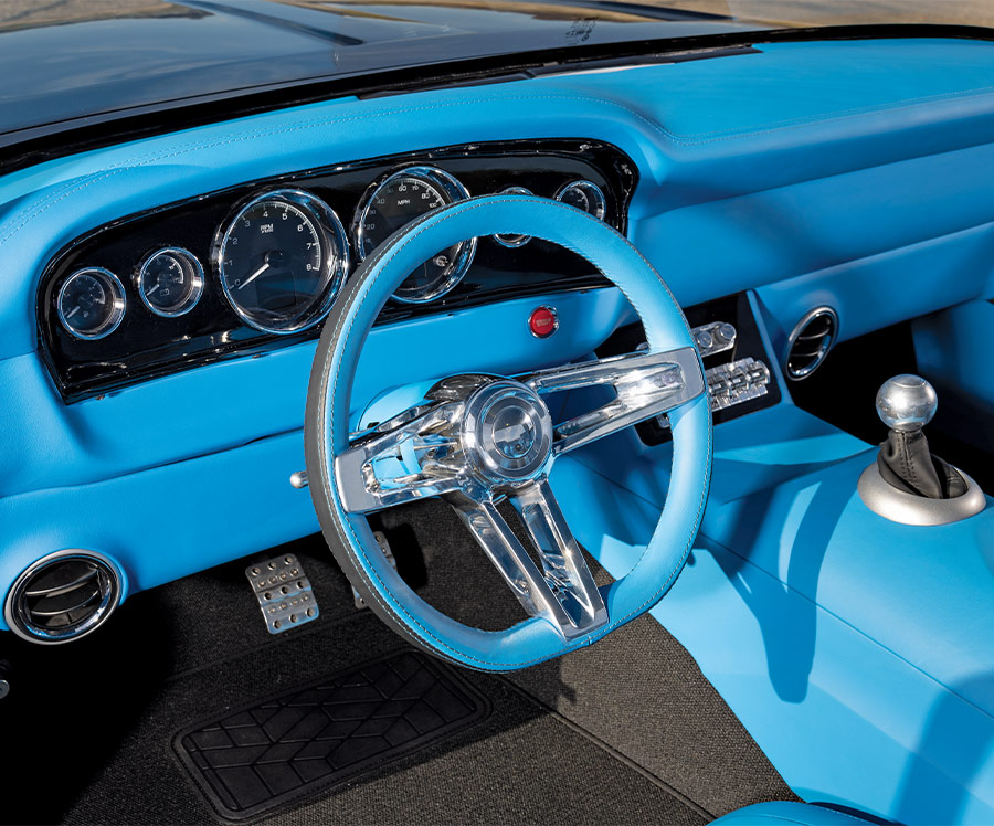 Steering wheel and center console of the 1961 Ford F-100 with a sleek, modern design in blue