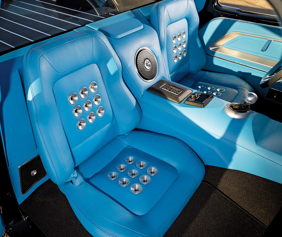 Dashboard of the 1961 Ford F-100 featuring custom blue upholstery and modern gauges