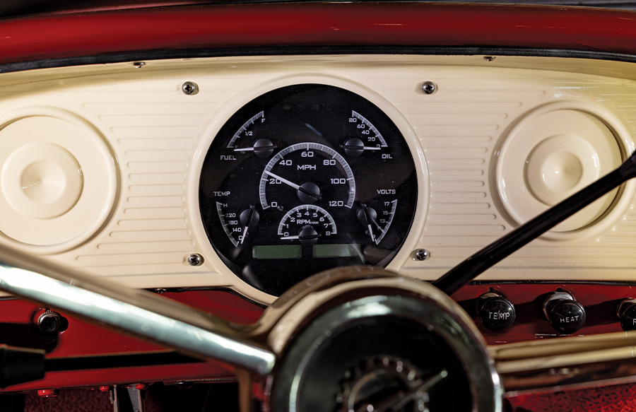 Close-up of the Ford F-100's vintage dash, with custom gauges and classic knobs, blending old-school style with modern tech