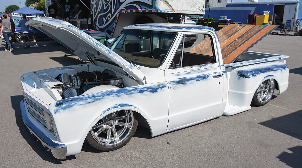 1967 Chevrolet C10 with a custom white and blue paint job, lowered suspension, and polished wheels