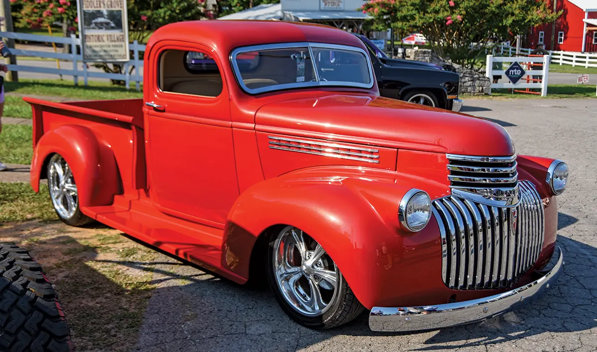 red 1946 Chevrolet Pickup with modern wheels and a smooth, custom-painted exterior