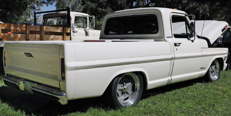 Rear view of a lowered 1967 Ford F100 in white with custom wheels