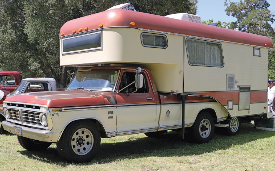 Vintage 1974 Ford F350 Camper Special with a worn red and cream camper setup