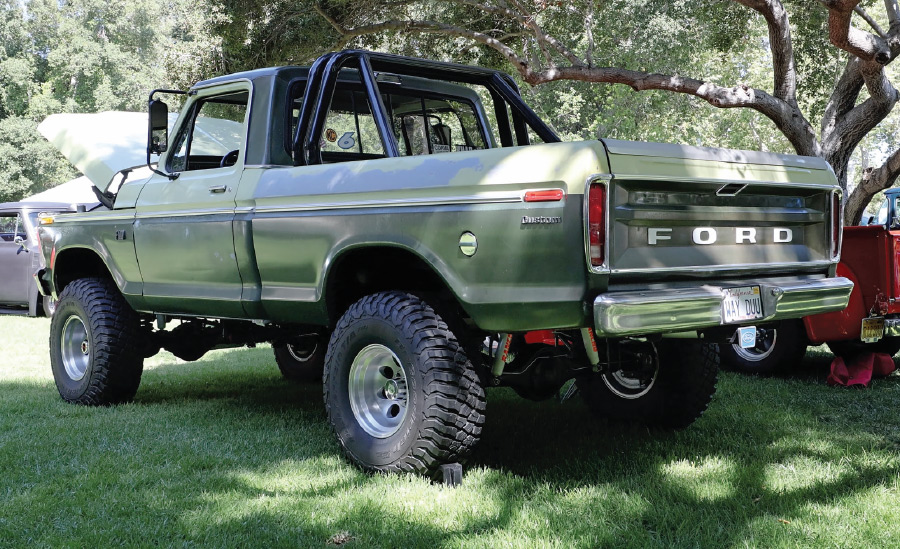Lifted 1977 Ford F150 in metallic green with roll bars and off-road tires