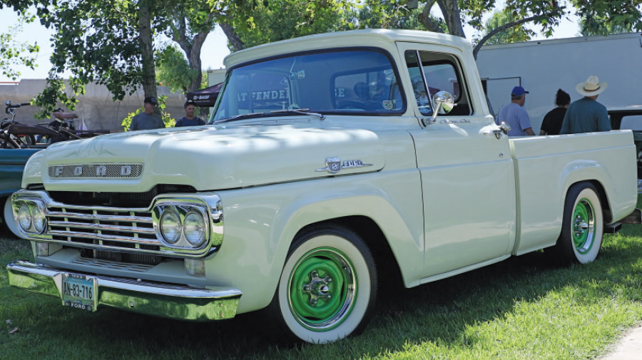 Pristine 1959 Ford F100 in white with chrome accents and green wheels
