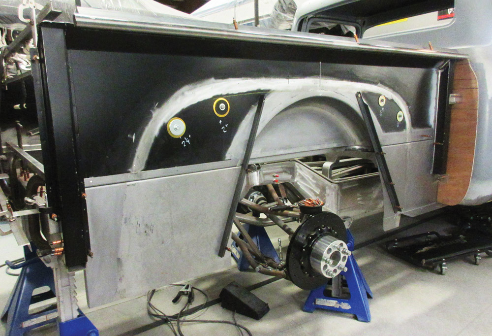 Rear view of the custom-fabricated F-100 bed with wheel tubs and suspension visible
