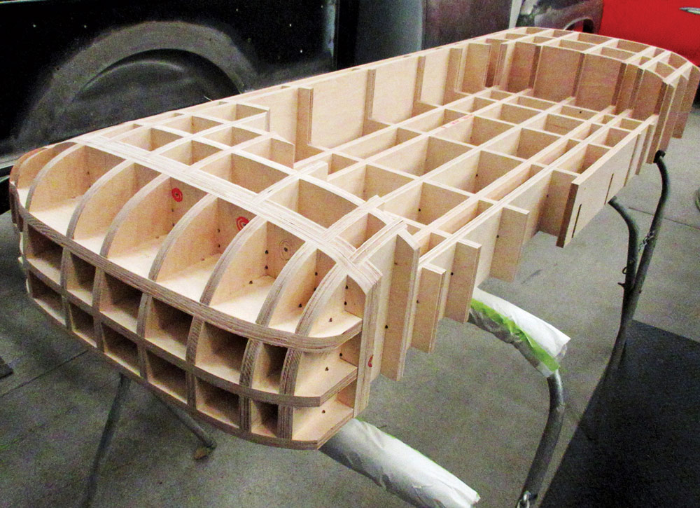 Wooden grid framework likely used for shaping or supporting parts