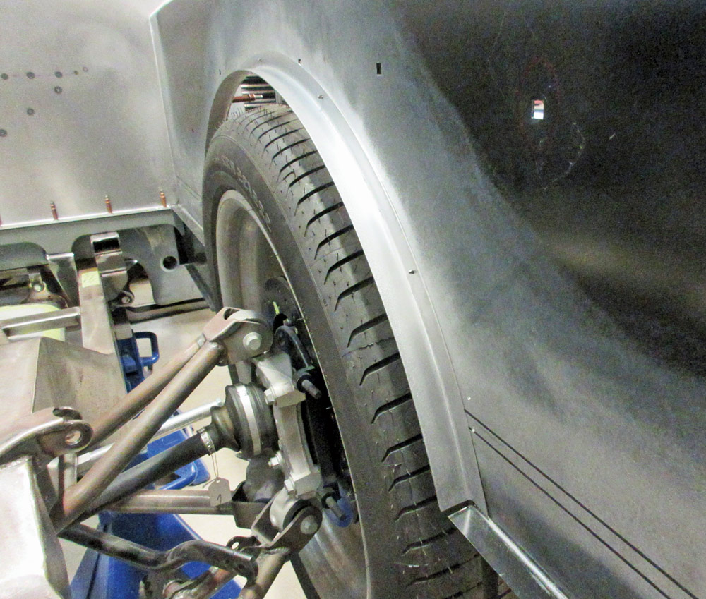 Test fitting the newly fabricated wheel arches around the tires on the F-100 bed