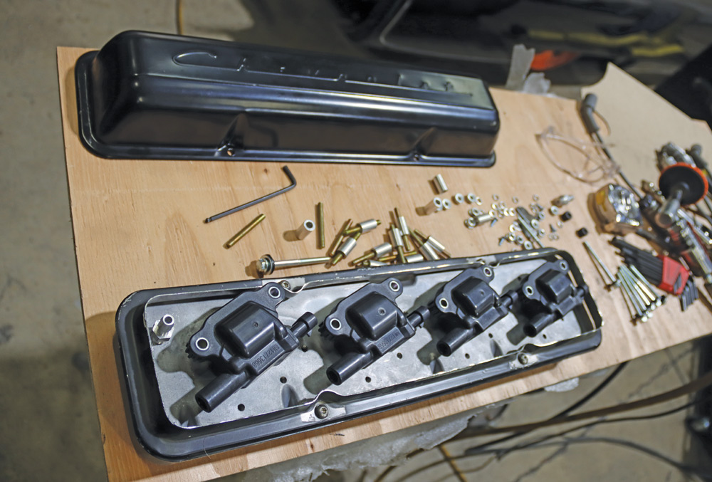 Chevy K10 valve cover assembly with ignition coils, awaiting installation