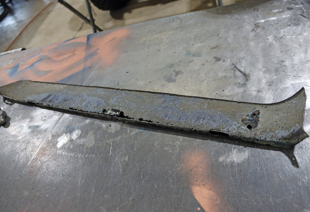 Removed, rusted rocker panel from a Chevy K10, ready for replacement in the restoration process