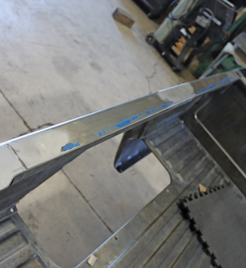 Sanded and prepped tailgate of a Chevy K10 in bare metal, awaiting primer