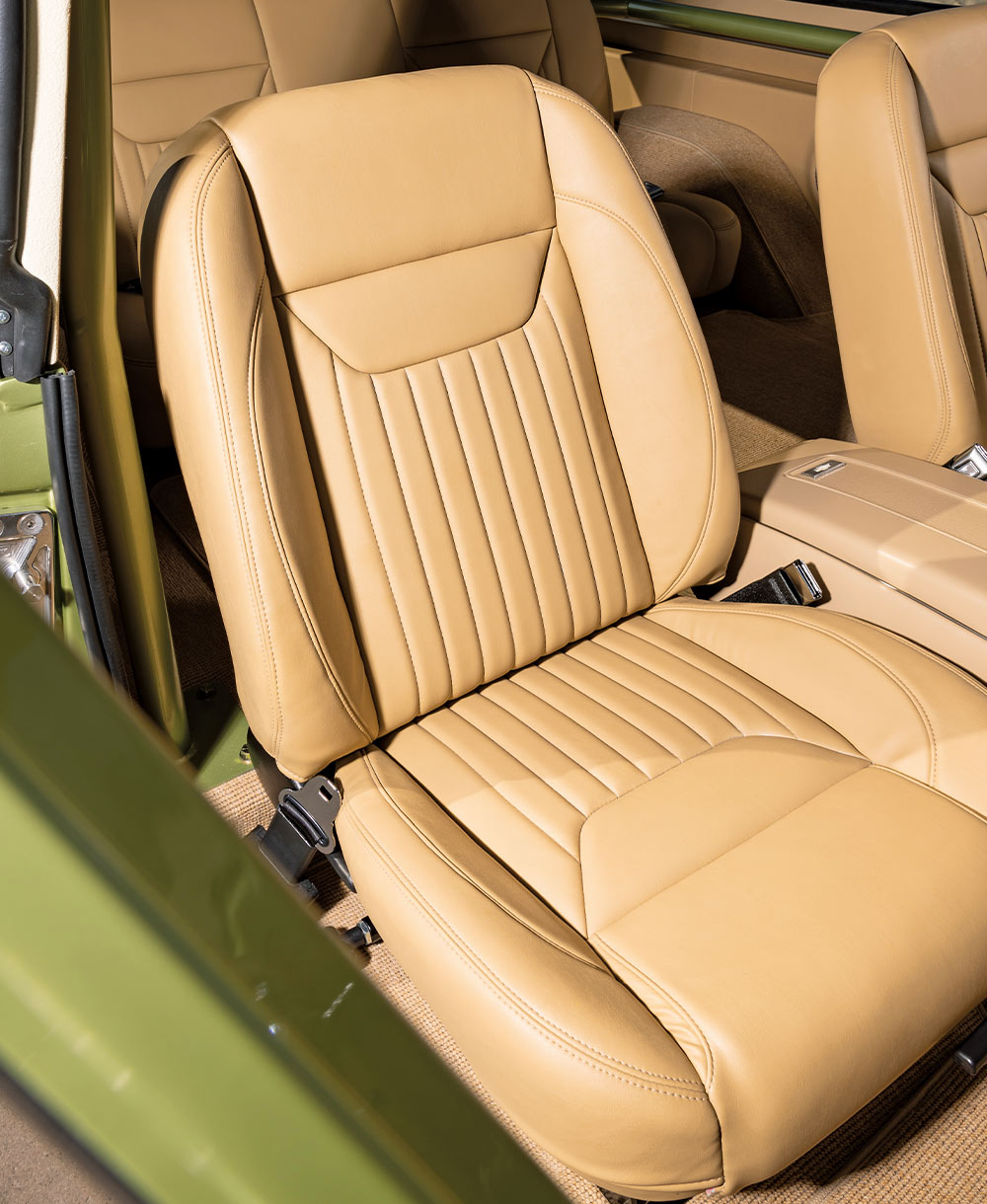 rear cargo area of K5 Blazer with a green Coleman cooler, tan interior