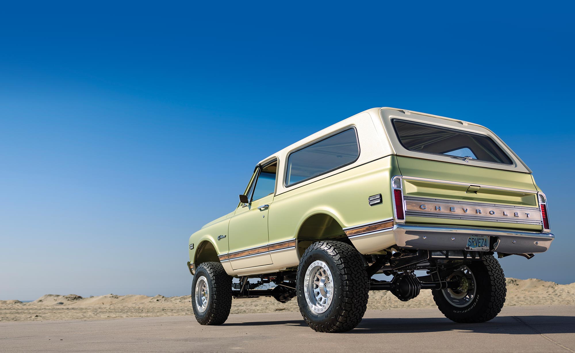 classic K5 Blazer dashboard, tan and green interior, beach visible through windows