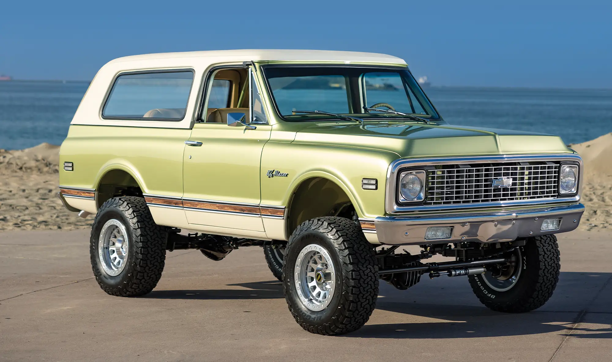 1970s K5 Blazer off-road SUV, yellow with white hardtop, ocean view