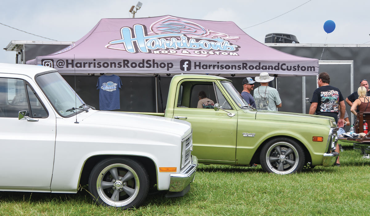 classic trucks displayed at Harrison’s Rod Shop booth during an event