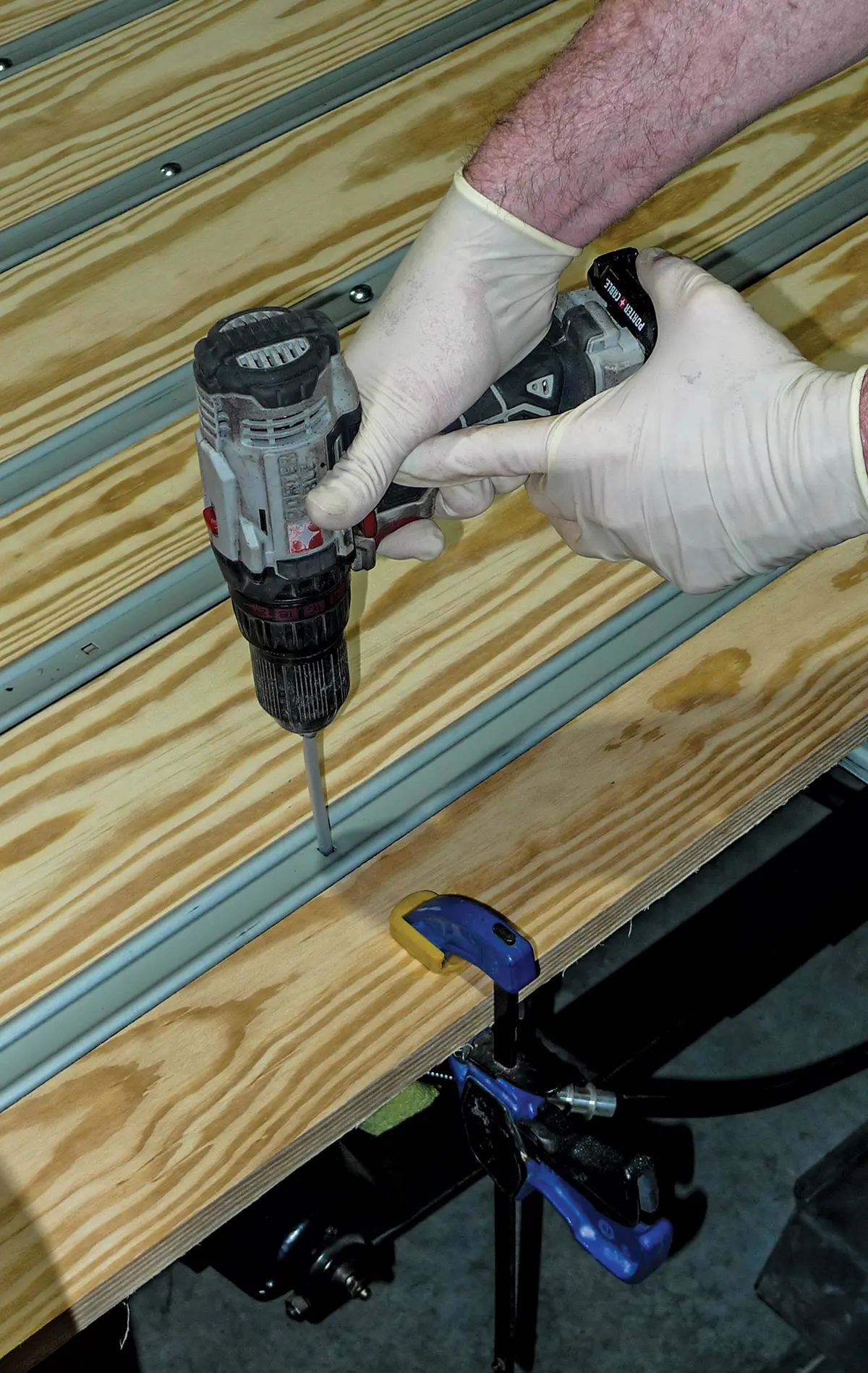 Securing the wood planks with a drill for the truck bed installation