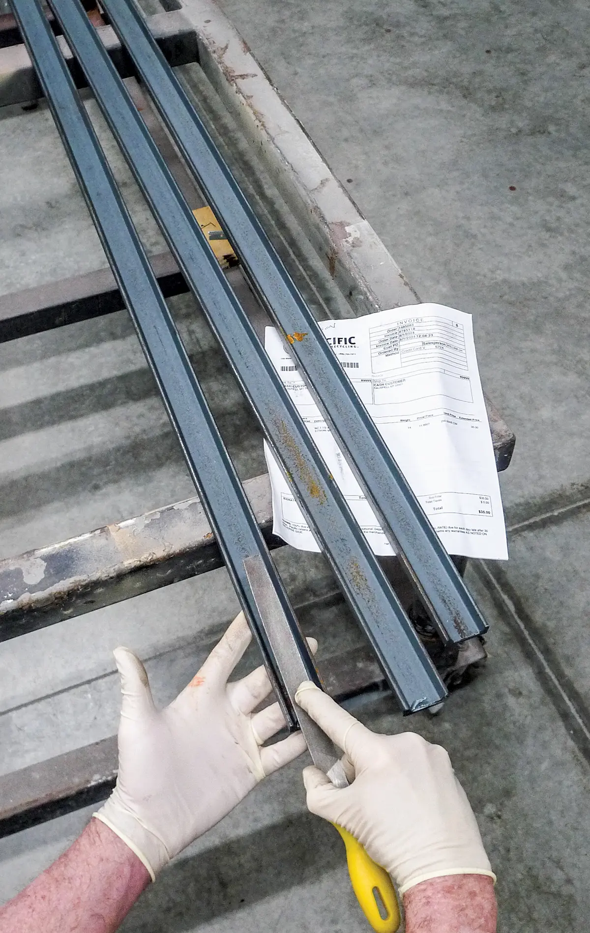 Filing metal rails to ensure smooth edges for bed installation