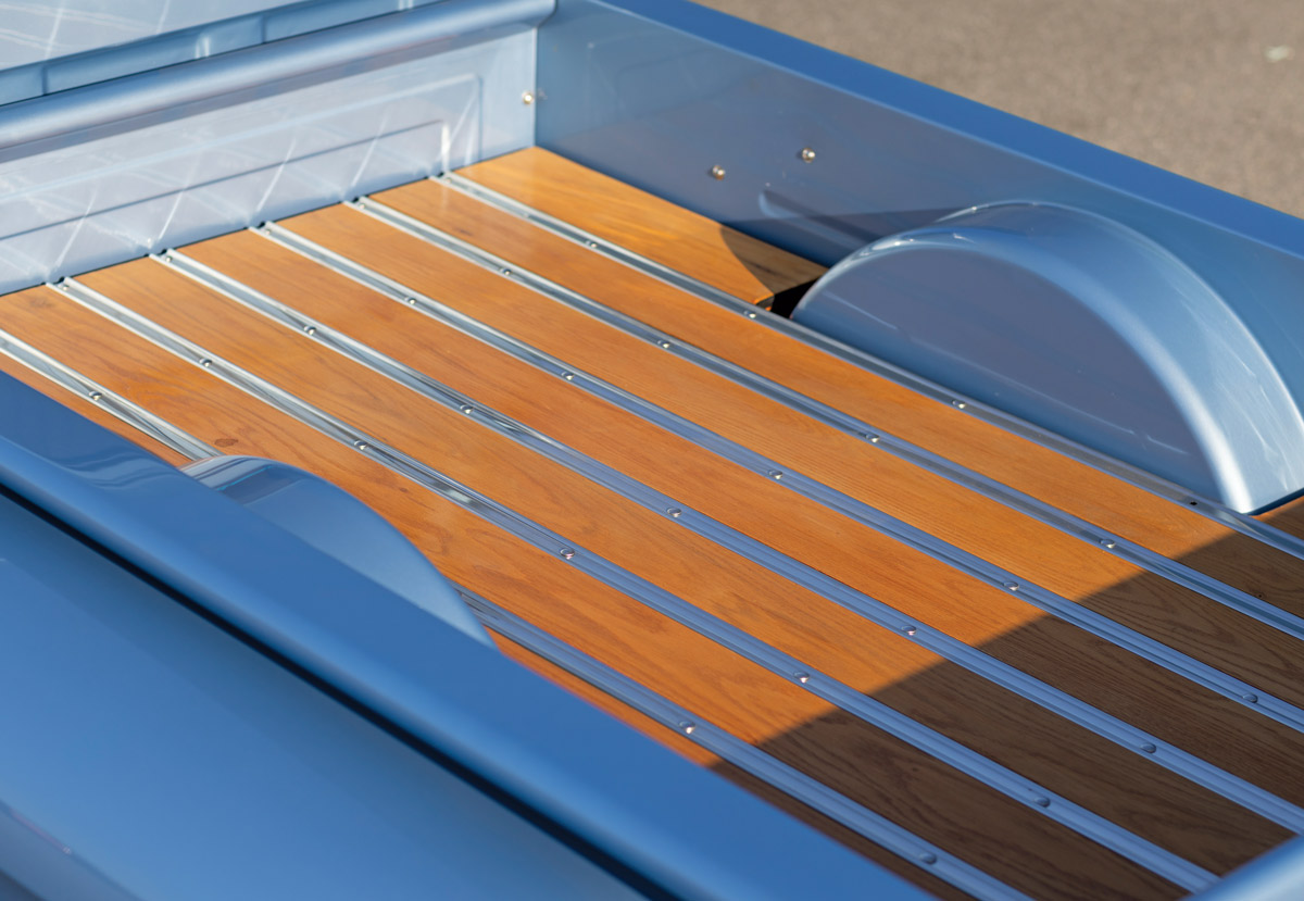 1955 Chevy truck bed featuring wood planks and polished metal accents