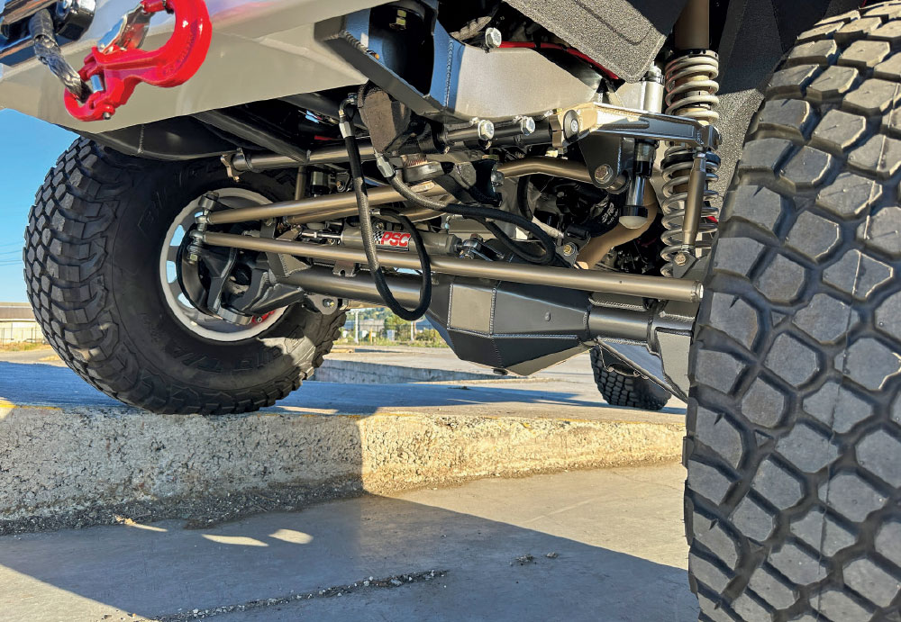 Close-up of GMC K2500’s undercarriage, showing heavy-duty PSC steering components and upgraded axles