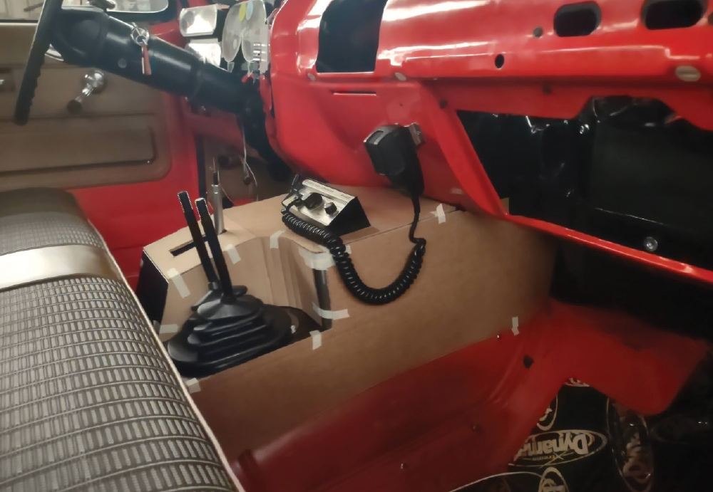 Interior view of GMC K2500 with a cardboard mockup console for gear levers and communication equipment