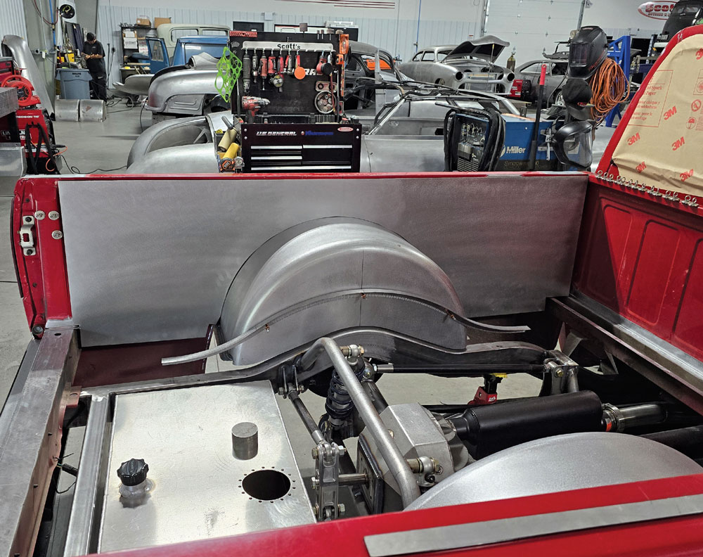 Rear view of Chevy OBS truck bed with fitted metal panels and wheel tubs