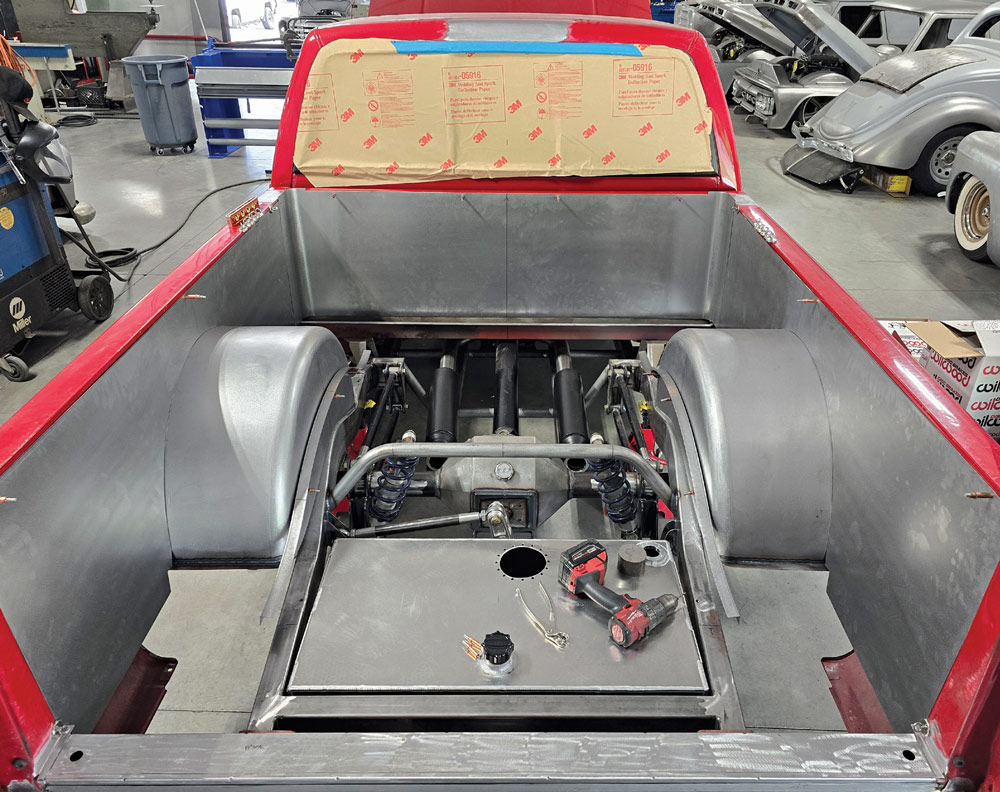 Custom-fabricated bed floor and fuel cell mount with metal finish in Chevy OBS truck