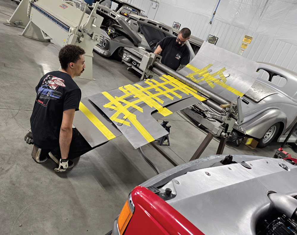 Fabricators marking metal bed panels for precision cuts on Chevy OBS truck project