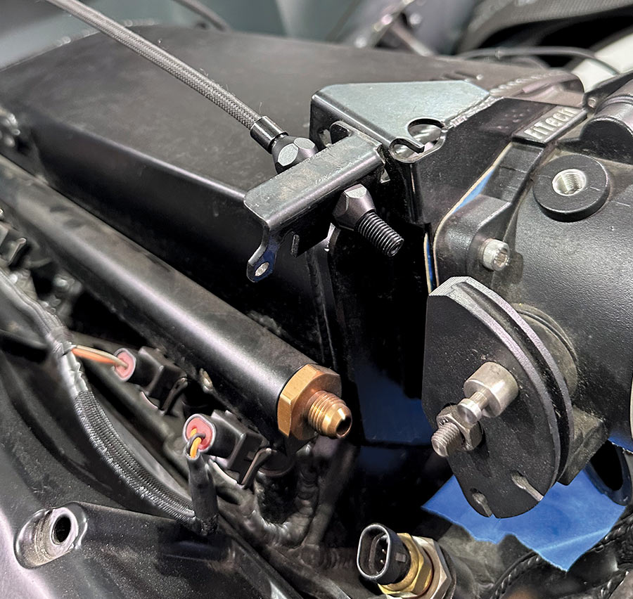 Fully installed Lokar throttle cable connected to throttle body, ready for testing